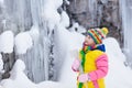 Children play with icicle in snow. Kids winter fun Royalty Free Stock Photo