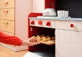 Children play in kitchen. Baking homemade cookies in toy oven