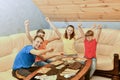 Children play loto. A friendly family spends leisure time playing board games