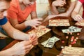 Children play loto and rearrange the chips with their hands