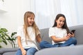 Children play with a mobile phone at home Royalty Free Stock Photo