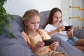 Children play with a mobile phone at home Royalty Free Stock Photo