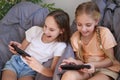 Children play with a mobile phone at home Royalty Free Stock Photo