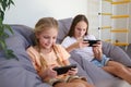 Children play with a mobile phone at home Royalty Free Stock Photo