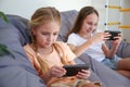 Children play with a mobile phone at home Royalty Free Stock Photo