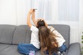 Children play with a mobile phone at home Royalty Free Stock Photo