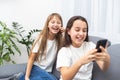 Children play with a mobile phone at home Royalty Free Stock Photo