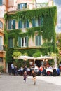 Children play near the outdoor cafe tables in Rome, Italy