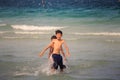 Children Play in Ocean Waves on Sunny Day in Vietnam Royalty Free Stock Photo