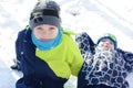 Children play outdoors in snow. Happy boys playing on a winter walk in nature Royalty Free Stock Photo