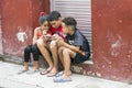 Children play with a phone in Havana, Cuba Royalty Free Stock Photo