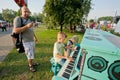 Children play piano with father on a green playground Royalty Free Stock Photo