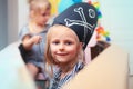 Children play pirates at home. Children in pirate costumes are sitting in a cardboard sea pirate ship. Entertainment at home. Royalty Free Stock Photo