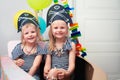 Children play pirates at home. Children in pirate costumes are sitting in a cardboard sea pirate ship. Entertainment at home. Royalty Free Stock Photo