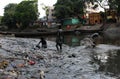 Children play in the polluted waters of Aadi Ganga.