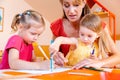 Children and play school teacher drawing together Royalty Free Stock Photo