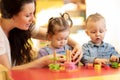 Children play with shapes and colorful wooden puzzle in a montessori classroom Royalty Free Stock Photo