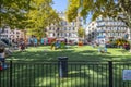 Children play in a small fenced playground school yard in the urban center of Nice France. Royalty Free Stock Photo