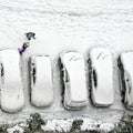 Children play in snow around cars in parking lot Royalty Free Stock Photo