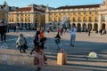 children play with soap bubbles on the main square of the city, happy people enjoy warm sunny evening