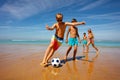 Children play soccer ball on a beach near the sea Royalty Free Stock Photo