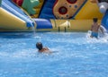 Children play and swim in pool. Two children are having fun in pool. Friends splashing in pool having fun leisure time. Summer Royalty Free Stock Photo