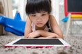 Children play Tablet on Living room carpet Royalty Free Stock Photo