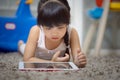 Children play Tablet on Living room carpet Royalty Free Stock Photo
