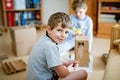 Children play with a toy designer on the floor of the children's room. Two kid boys playing with colorful blocks Royalty Free Stock Photo