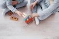 Children play with a toy designer on the floor of the children`s room. Two kids playing with colorful blocks Royalty Free Stock Photo