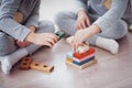 Children play with a toy designer on the floor of the children`s room. Two kids playing with colorful blocks Royalty Free Stock Photo