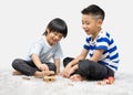 Children play with a toy designer on the floor of the children`s room. Two kids playing with colorful blocks. Royalty Free Stock Photo