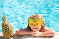 Children play in tropical resort. Little boy child having fun in swimming pool. Summer pineapple fruit. Royalty Free Stock Photo