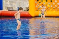 Children play in the water pool. Two boys playing with ball in an inflatable pool Royalty Free Stock Photo