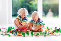 Children play wiht toy train. Kids wooden railway. Royalty Free Stock Photo