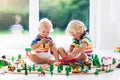 Children play wiht toy train. Kids wooden railway. Royalty Free Stock Photo