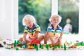 Children play wiht toy train. Kids wooden railway. Royalty Free Stock Photo