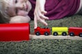 Child boy play with wooden train, build toy railroad at home or Royalty Free Stock Photo