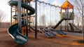 Children Playground with Modern Slide, Rope Net Bridge, Climbing Swings, Climbers. Empty Wooden Playground made of Eco Royalty Free Stock Photo