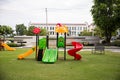 Children playground on yard activitie in public park rounded by green tree at sunlight morning. Royalty Free Stock Photo