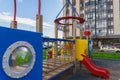 Children playground on yard activities in public park surrounded by green trees at sunlight morning. Children run, slide, swing, Royalty Free Stock Photo