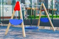 Children playground on yard activities in public park surrounded by green trees at sunlight morning. Children run, slide, swing, Royalty Free Stock Photo