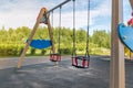 Children playground on yard activities in public park surrounded by green trees at sunlight morning. Children run, slide, swing, Royalty Free Stock Photo