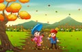 Children playing with autumn fallen leaves in park Royalty Free Stock Photo