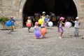 Children playing with balloons on Plaza Mayor, in Ainsa, Huesca, Spain in Pyrenees Mountains, an old walled town with hilltop view Royalty Free Stock Photo