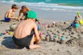 Children playing on the beach. Boys in the sand. Happy children play on the shore.