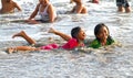 CHILDREN PLAYING AT THE BEACH IN INDONESIA