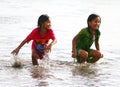 CHILDREN PLAYING AT THE BEACH IN INDONESIA