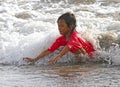 CHILDREN PLAYING AT THE BEACH IN INDONESIA