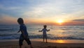 Children playing on the beach at sunset. sea, Travel and vacation concept, Summer time concept Royalty Free Stock Photo